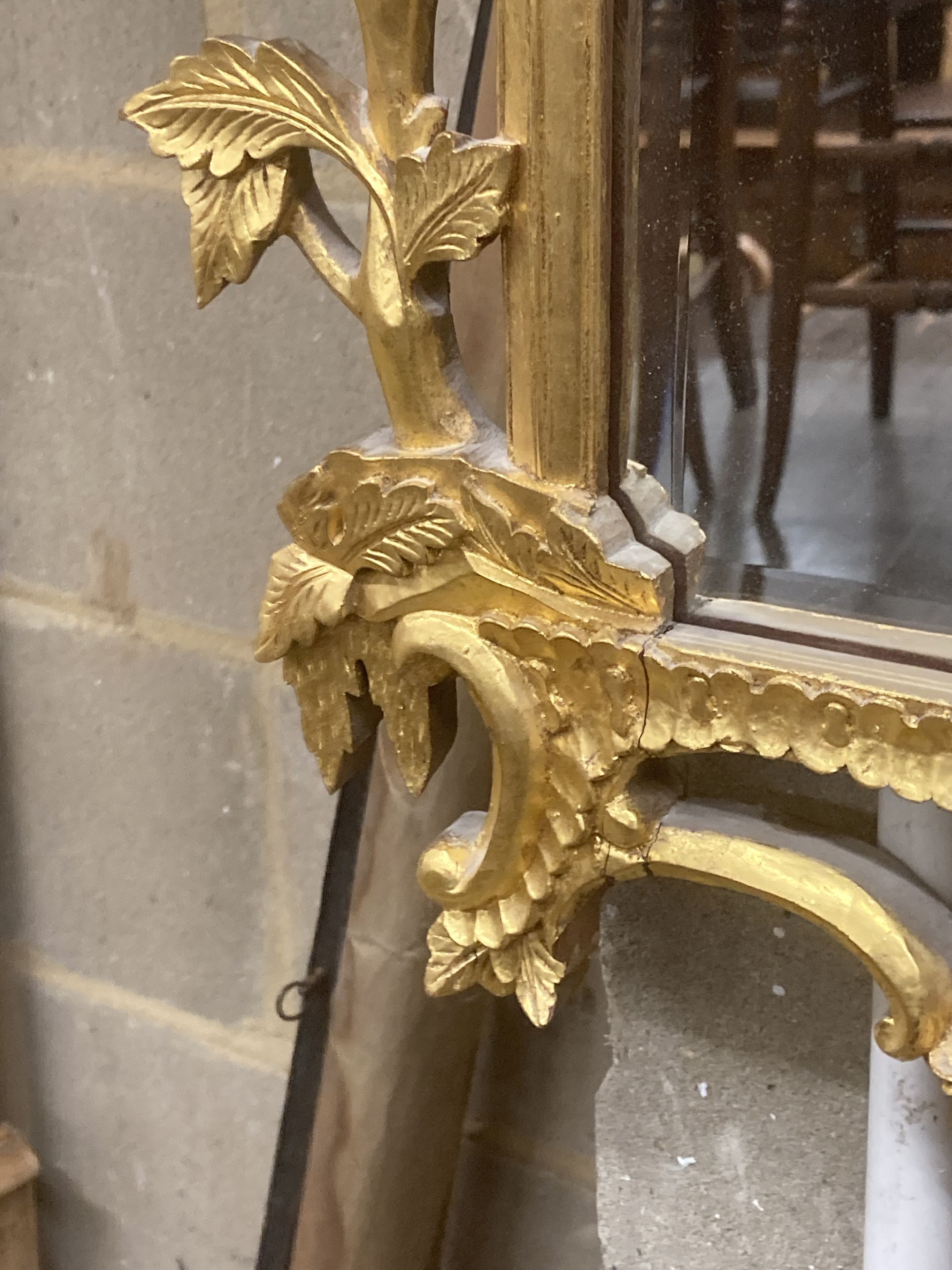 A George III style decorative carved giltwood wall mirror, width 63cm, height 106cm